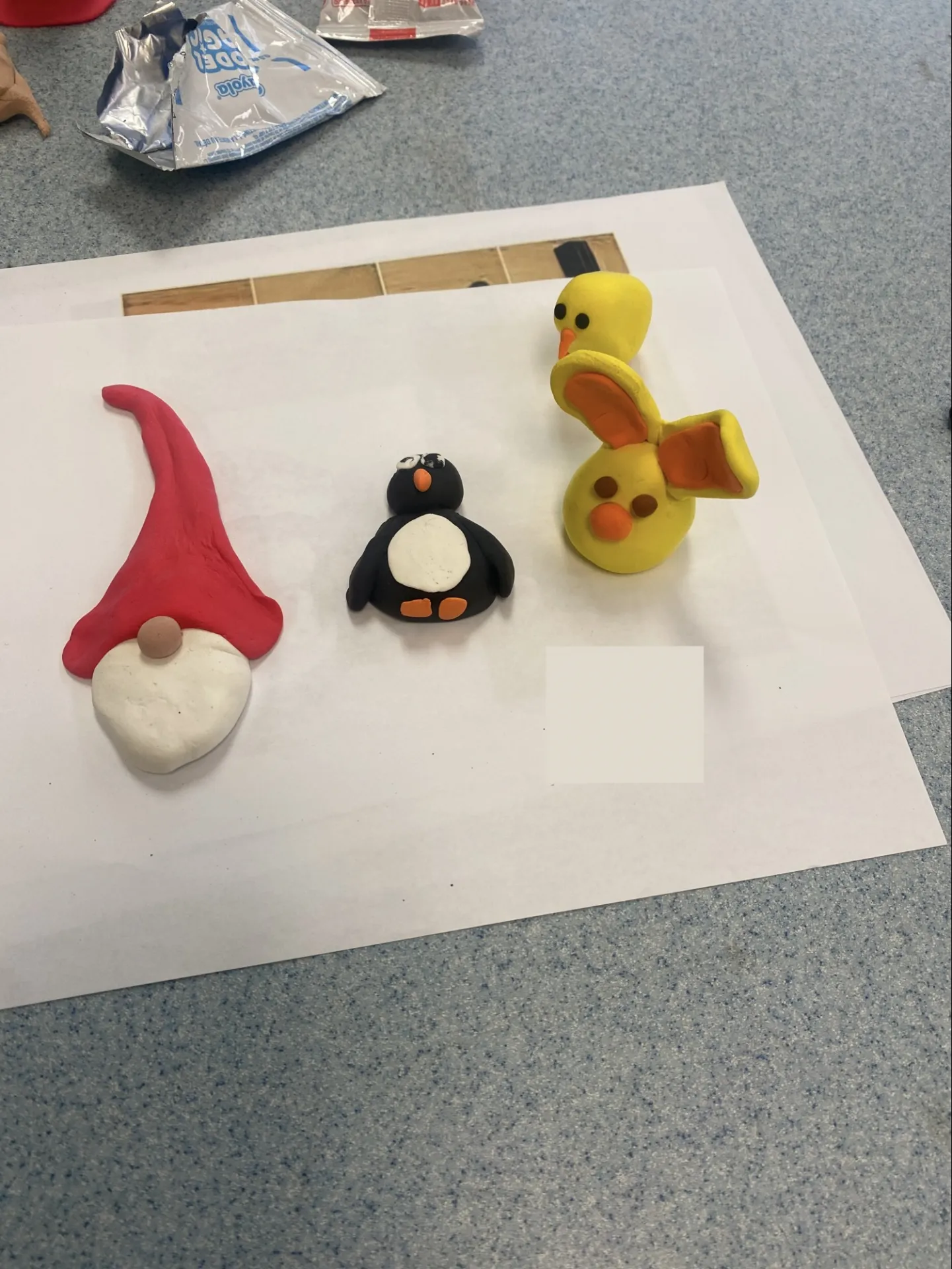 Crafts made at the arts and crafts fair. It depicts a clay gnome, penguin, and bunny.